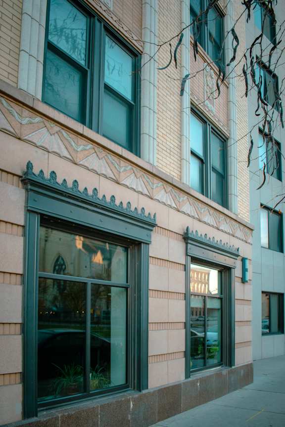 A building with a pink facade and a large window.