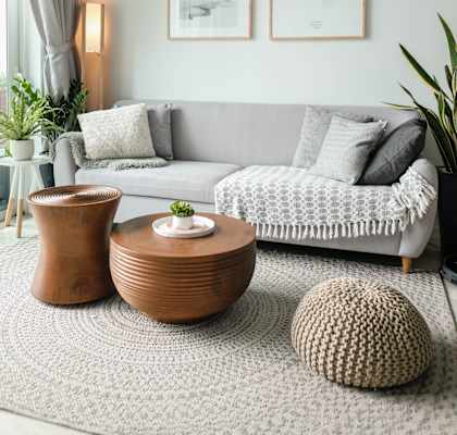 a living room with a grey couch and two coffee tables