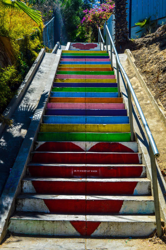 a set of colorful stairs painted in the shape of a heart