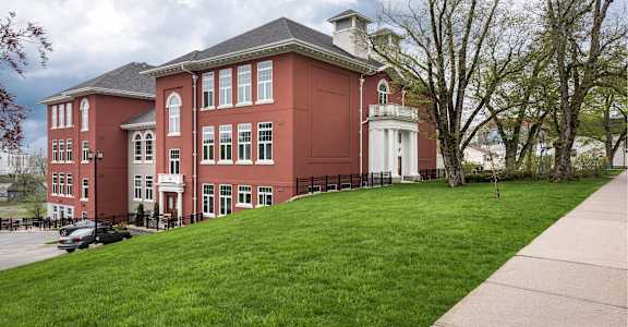 A red building with a white door and windows.