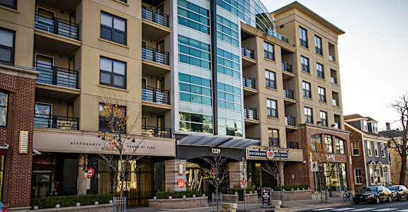 A street view of a building with a restaurant on the ground floor.