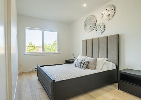 a bedroom with a large bed and a window