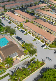 an aerial view of a parking lot with a swimming pool