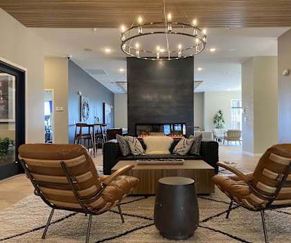 a large living room with a fireplace and a chandelier