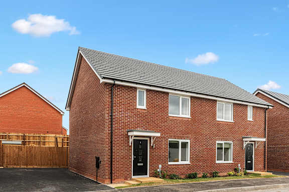 A red brick house with a black door and windows.