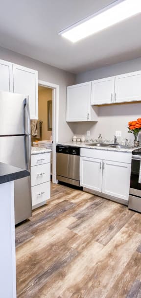 a kitchen with stainless steel appliances and white cabinets