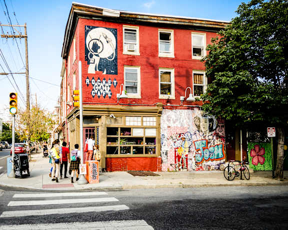A red building with a mural of a skull on it.