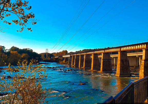 a bridge over a river with a blue sky in the background