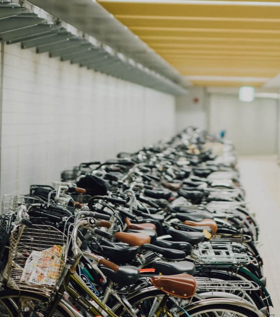 a long row of bikes parked in a room