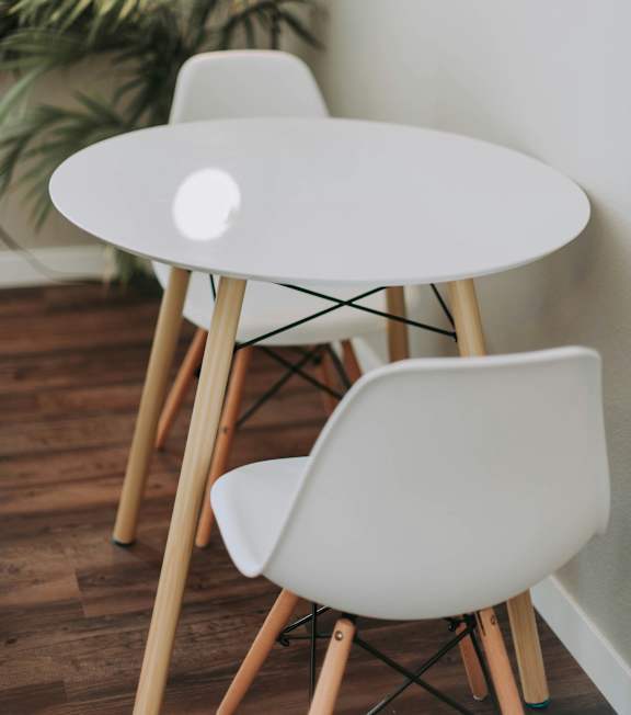 a desk with a chair and a lamp in a room