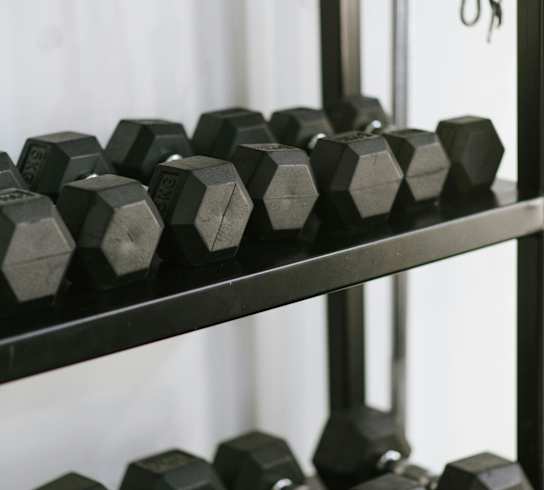 weights on a rack in a gym