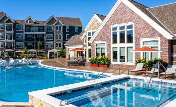 a swimming pool with an apartment building in the background  at Waterside Residences on Quivira, Lenexa, KS