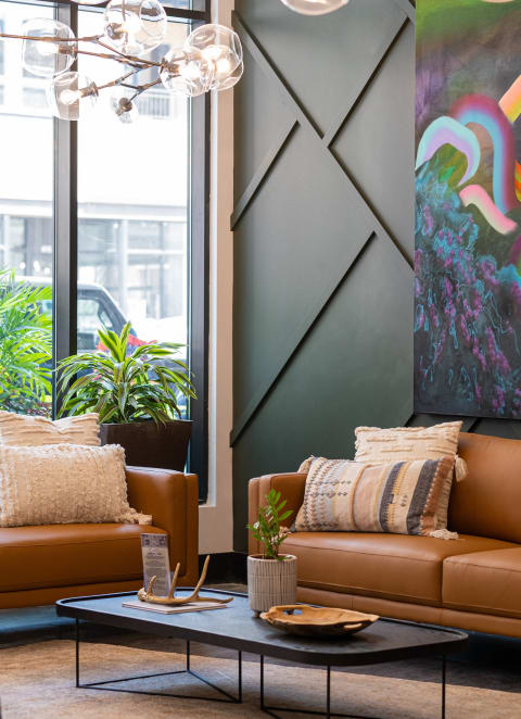 A living room with brown couches and a coffee table at Kesler Apartments in Downtown Fargo, Fargo, ND 58102