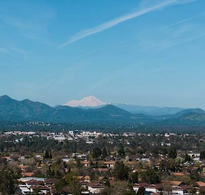a view of the city and mountains in the distance