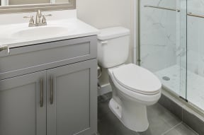 a bathroom with a toilet sink and shower