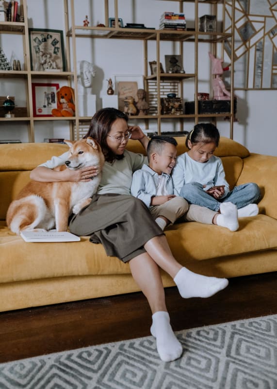 a man and a woman sitting on the floor with a dog