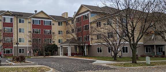 an apartment complex with a car parked in the driveway