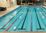 Thumbnail 1 of 8 - A large indoor swimming pool with lanes marked by floating lane dividers at Ironwood Apartments, Coeur d'Alene, Idaho