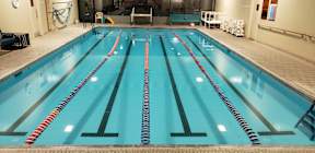 A large indoor swimming pool with lanes marked by floating lane dividers at Ironwood Apartments, Coeur d'Alene, Idaho