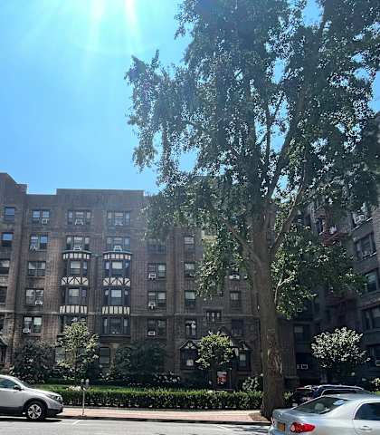 a parking lot in front of a large apartment building