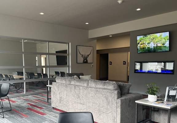 a living room with a couch and tables and a tv