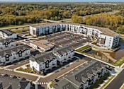 Thumbnail 1 of 4 - A bird's eye view of a residential area with houses and apartment buildings.