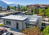 Thumbnail 25 of 28 - A modern building with a parking lot in front of it. at Siena Villas Apartments, Orem, UT, 84097