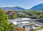 Thumbnail 22 of 28 - A parking lot in front of a building with a mountain in the background. at Siena Villas Apartments, Orem, Utah