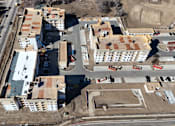 Thumbnail 4 of 8 - an aerial view of a city with buildings and a road