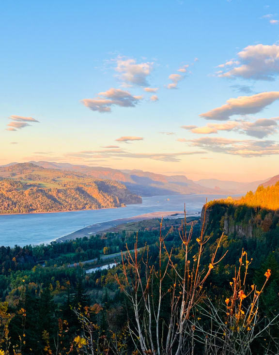 a view of a lake in the mountains at sunset