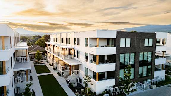 A modern residential complex with white and black buildings.