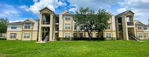 A large apartment complex with multiple buildings and green lawns.