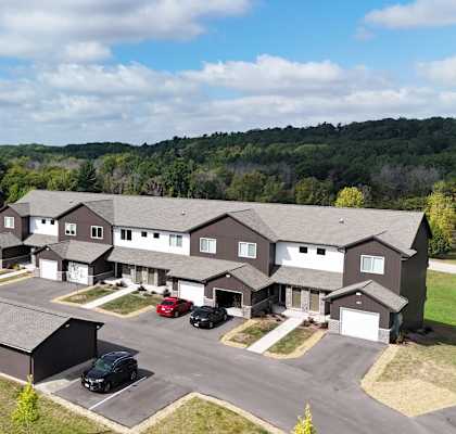 a aerial view of a group of houses and a parking lot