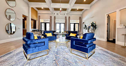 a living room with blue chairs and a rug at Waterstone at Cinco Ranch, Katy, TX, 77450