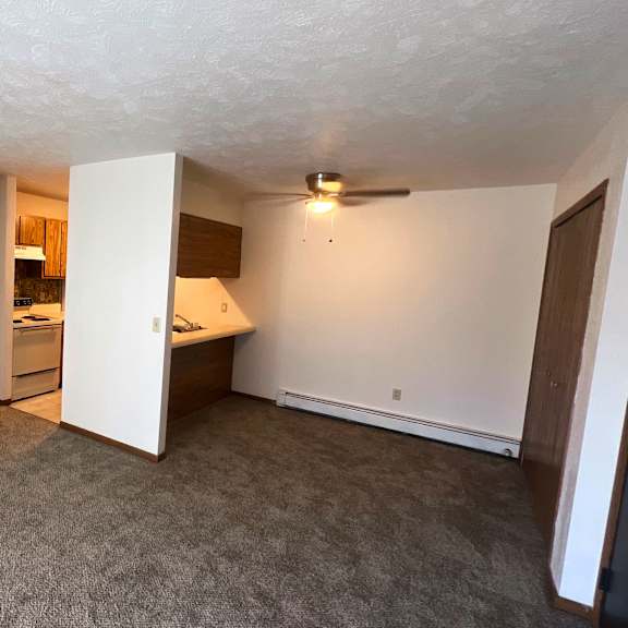 a white bedroom with a large bed and a window
