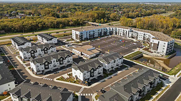 A bird's eye view of a residential area with houses and apartment buildings.