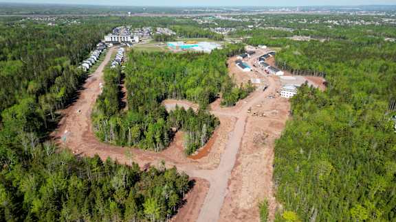 An aerial view of a construction site surrounded by trees.