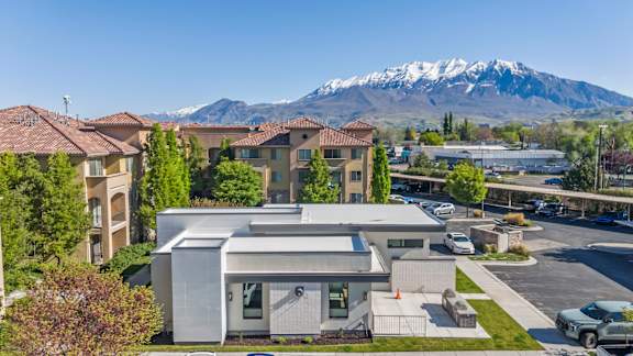A modern building with a mountain in the background.
