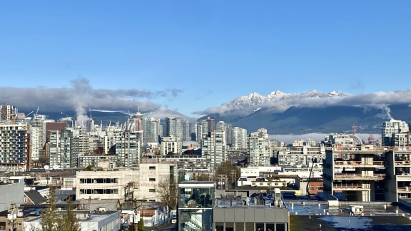 a view of the city and mountains in the background