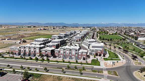 an aerial view of a city with buildings and a highway