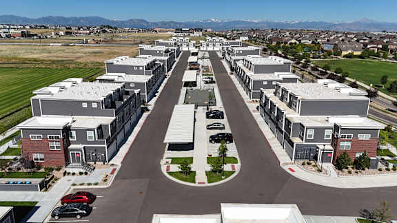 an aerial view of a neighborhood with houses and cars parked on the street