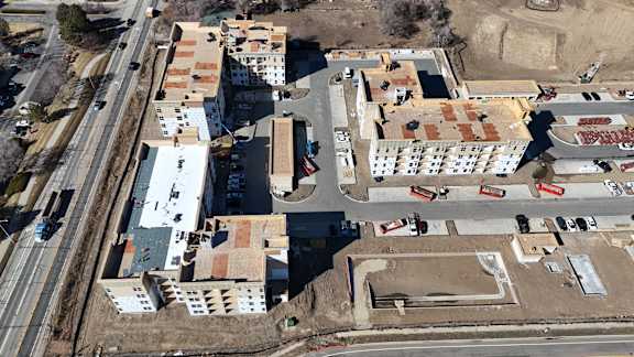 an aerial view of a city with buildings and a road