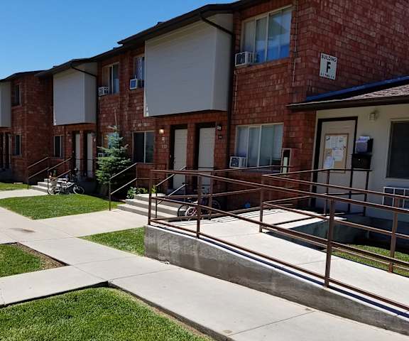 an apartment building with stainless steel railings and concrete sidewalks
