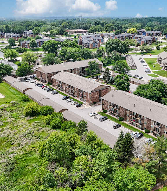 A large building complex with a parking lot in front.