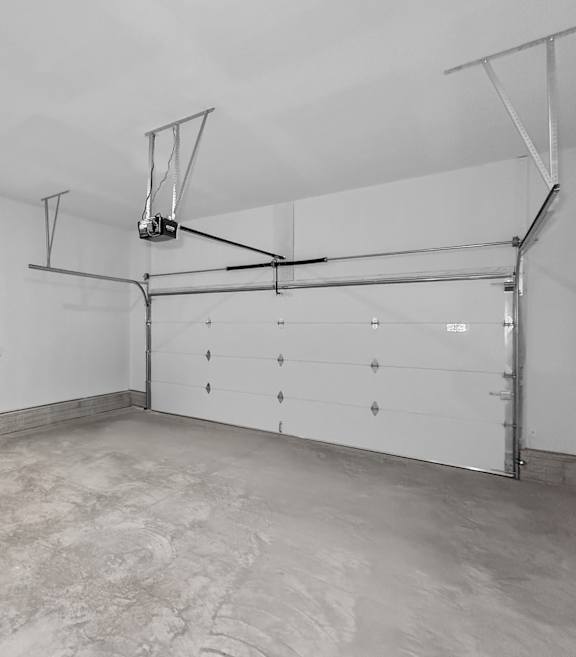A white room with a basketball hoop and a white door.