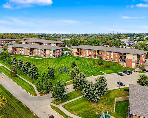 A large apartment complex with multiple buildings and green lawns.