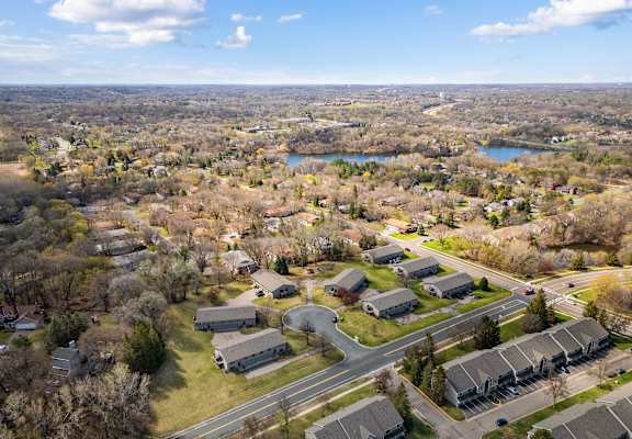 an aerial view of a neighborhood with houses and a lake