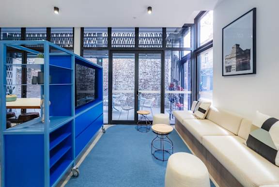 a living room with a blue shelving unit and a white couch