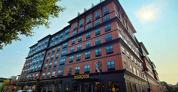 A large red building with the word "Marquis" on the front.