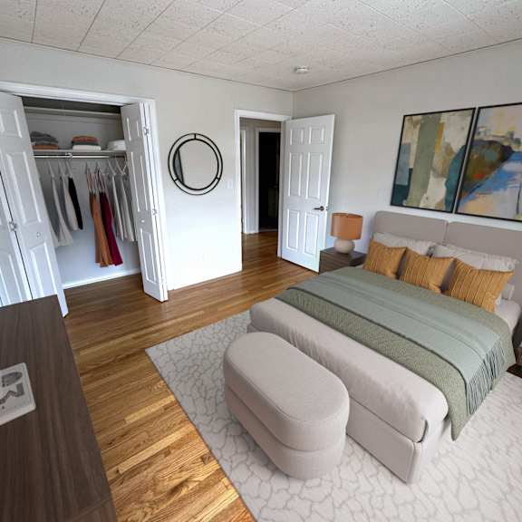 A bedroom with a bed, a wardrobe, and a mirror.